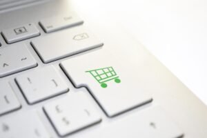 White keyboard with the Enter key replaced by a shopping cart icon representing online purchases.