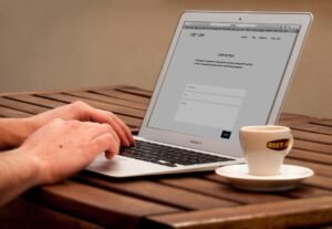 Person using a laptop to test website functionality and performance.